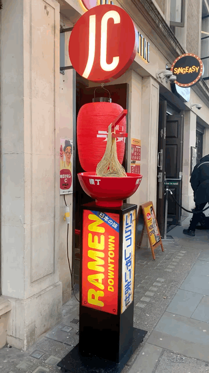advertising stand with moving noodles in a bowl